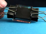 TiO2 sample held by 2 small binder clips