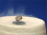 Superconductor, small magnet floating over foam that has mist from liquid nitrogen