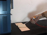 hand Spraying tile on top of table