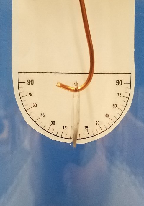 close image of electroscope leaves and angles behind
