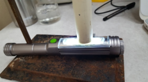 A light shines up a PVC tube