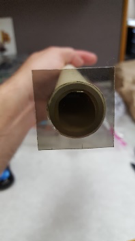 A polarizer taped to the end of a PVC pipe