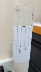 Paper protractor taped around a PVC pipe